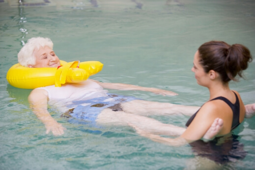 Instructor And Elderly Patient Undergoing Water Therapy